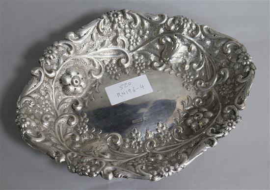 An Edwardian repousse silver oval bread dish, William Mammat & Son, Sheffield, 1904, 8 oz.